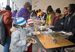 Two girls receive food at an outdoor soup kitchen in Washington. (CNS photo/Jim West)