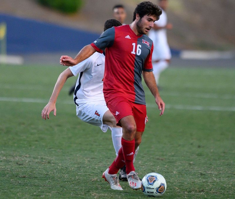 LMU’s Leo Zulli keeps the ball away from an attacker during a recent match. The Lions end their regular season this week in San Francisco. (LMU Athletics)