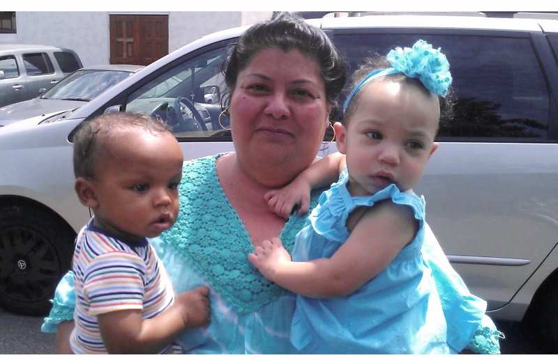 Cecilia Chavez holds two of the children whose lives were saved through Expectant Mothers Outreach. (Christa Chavez)