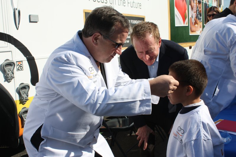 Jim Hannon, treasurer of the William H. Hannon Foundation, distributes glasses at Dolores Mission School. (Photo Courtesy William H. Hannon Foundation)