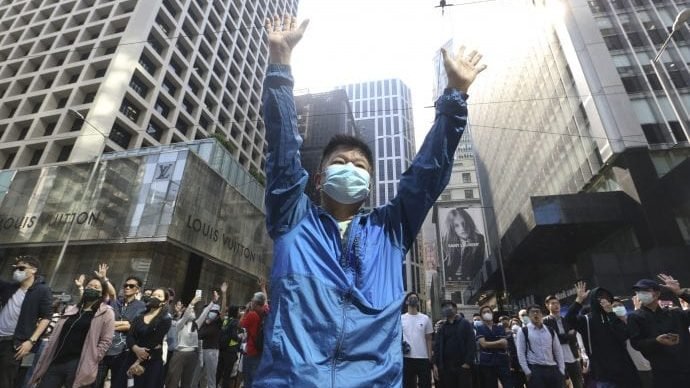 A demonstrator raises his hands during a protest in the financial district in Hong Kong, Friday, Nov. 15, 2019. (Achmad Ibrahim/AP)