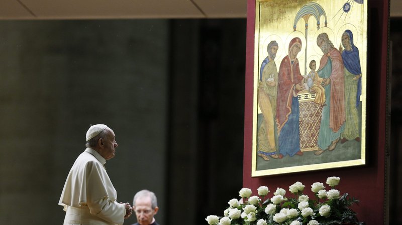 Pope Francis prays in front of an image of the Holy Family during a prayer vigil for the Synod of Bishops on the family in St. Peter's Basilica at the Vatican in 2015. (CNS/Paul Haring)