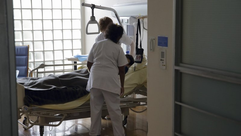 Nurses provide care to a patient in the palliative care unit of a hospital near Paris March 9, 2015. Religions share an understanding of the importance of caring for people's physical, emotional and spiritual needs, and this precious insight is especially needed in the field of palliative care, Archbishop Vincenzo Paglia said in a Dec. 10, 2019, news conference at the Vatican. (CNS photo/Philippe Wojazer, Reuters)