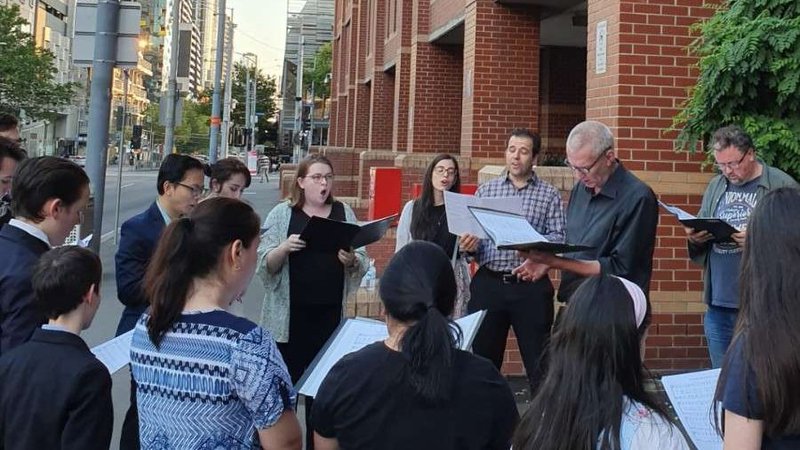 Carolers gather outside Melbourne Assessment Prison on Christmas Eve, 2019. (John Macauley/CNA)