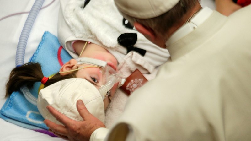 Pope Francis blesses a sick child in Paul VI hall at the Vatican Dec. 15, 2016, during a meeting with patients and workers of Rome's Bambino Gesu children's hospital. World Day of the Sick iis marked Feb. 11, the feast of Our Lady of Lourdes. (CNS photo/Max Rossi, Reuters)