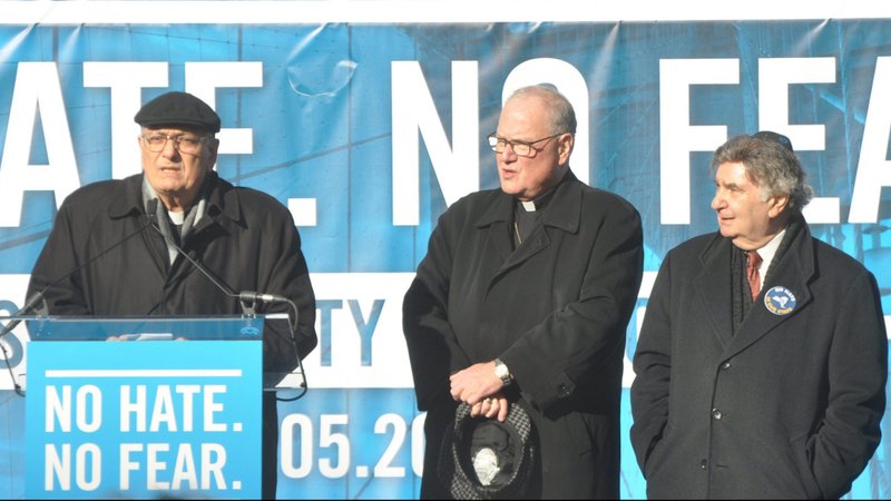 Bishop Nicholas DiMarzio of Brooklyn, N.Y., Cardinal Timothy M. Dolan, and Rabbi Joseph Potasnik, executive vice-president of the New York Board of Rabbis, speak from the podium in Brooklyn's Cadman Plaza during massive No Fear, No Hate rally, Jan. 5, 2020. (CNS photo/Ed Wilkinson, The Tablet)