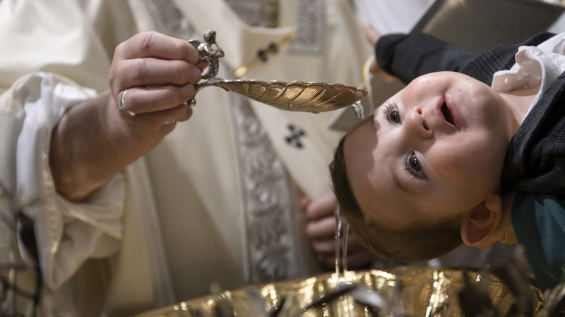 Pope Francis baptizes one of 32 babies as he celebrates Mass on the feast of the Baptism of the Lord in the Sistine Chapel at the Vatican Jan. 12, 2020. (CNS photo/Vatican Media)