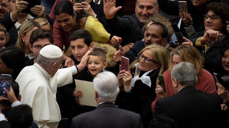 Pope Francis greets a child as he arrives for his general audience in Paul VI hall at the Vatican Jan. 22, 2020. (CNS photo/Vatican Media)