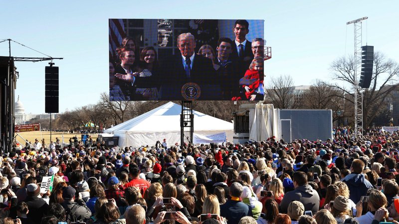 U.S. President Donald Trump is projected on a large video screen as he addresses attendees of the annual March for Life rally in Washington Jan. 19, 2018. His address took place in the Rose Garden at the White House. Trump said Jan. 23, 2020, he plans to attend the annual pro-life march Jan. 24, making him the first sitting president to address the rally in person. (CNS photo/Eric Thayer, Reuters)