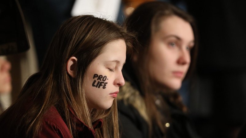 A young woman rests during the closing Mass of the National Prayer Vigil for Life Jan. 24, 2020, at the Basilica of the National Shrine of the Immaculate Conception in Washington. Many of the pilgrims traveled across the country - some even from abroad - to attend the 47th annual March for Life. (CNS photo/Bob Roller)