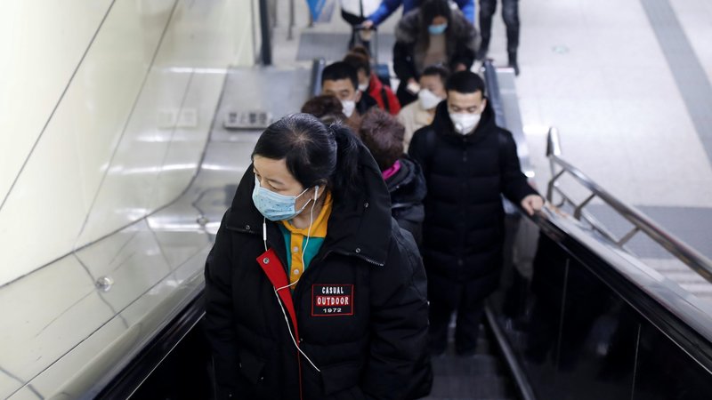 People wearing face masks are seen at the escalator of a Beijing subway station Jan. 27, 2020, as the country is hit by an outbreak of the new coronavirus.The virus has spread to almost every province in mainland China during Lunar New Year. (CNS photo/Carlos Garcia Rawlins, Reuters)