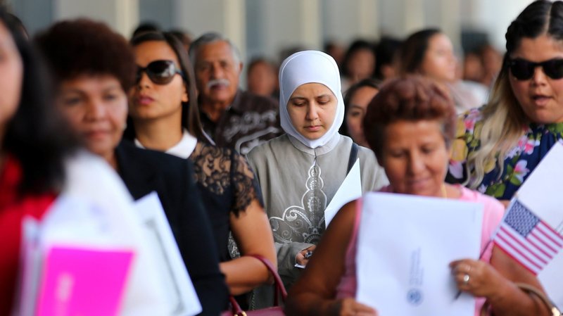Naturalized citizens leave a swearing-in ceremony in Los Angeles July 18, 2017. Catholic Charities USA and Catholic Legal Immigration Network, or CLINIC, expressed disappointment with the Supreme Court's Jan. 27, 2020, order allowing the Trump administration to go forward with a new rule meant to limit immigrants' use of government benefit programs. (CNS photo/Mike Blake, Reuters)