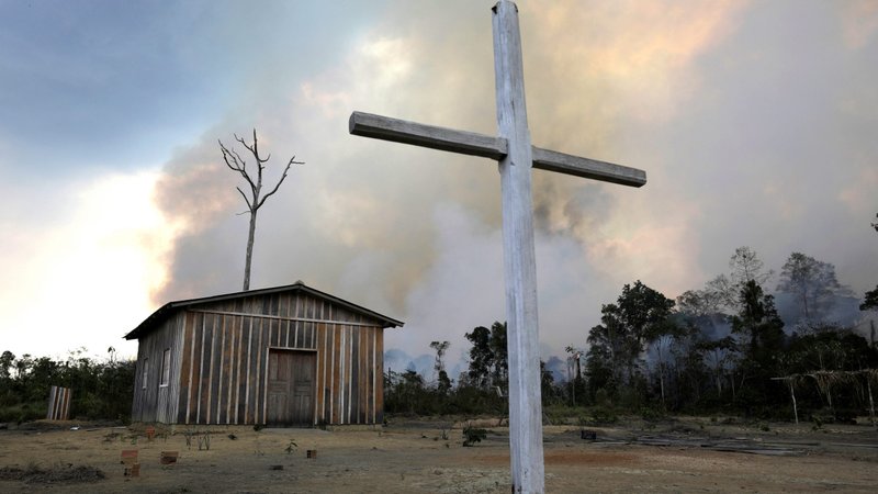 A wooden cross is seen in front of a Catholic church as a fire burns a tract of the Amazon jungle being cleared by loggers and farmers near Porto Velho, Brazil, Aug.27, 2019. The Vatican released Pope Francis' post-synodal apostolic exhortation, "Querida Amazonia" (Beloved Amazonia), Feb. 12, 2020. (CNS photo/Ricardo Moraes, Reuters)