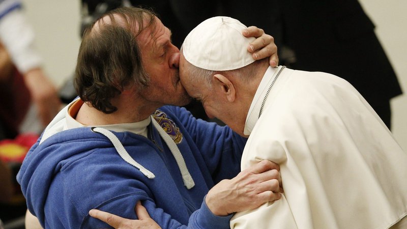 A man kisses Pope Francis during his general audience in Paul VI hall at the Vatican Feb. 19, 2020. (CNS photo/Paul Haring)