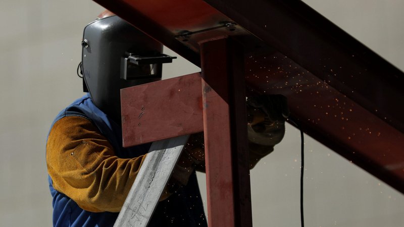 A construction worker uses a grinder on a metal beam at a construction site in Los Angeles Aug. 10, 2017. The Catholic Labor Network, through its Mid-Atlantic Construction Wage Theft Project, is looking into the issue of "wage theft," the denial of pay or benefits rightfully owed to workers. The project has sent a man to construction sites in Maryland and the District of Columbia to talk to workers to learn who hired them and how much they're getting paid. (CNS photo/Mike Blake, Reuters)