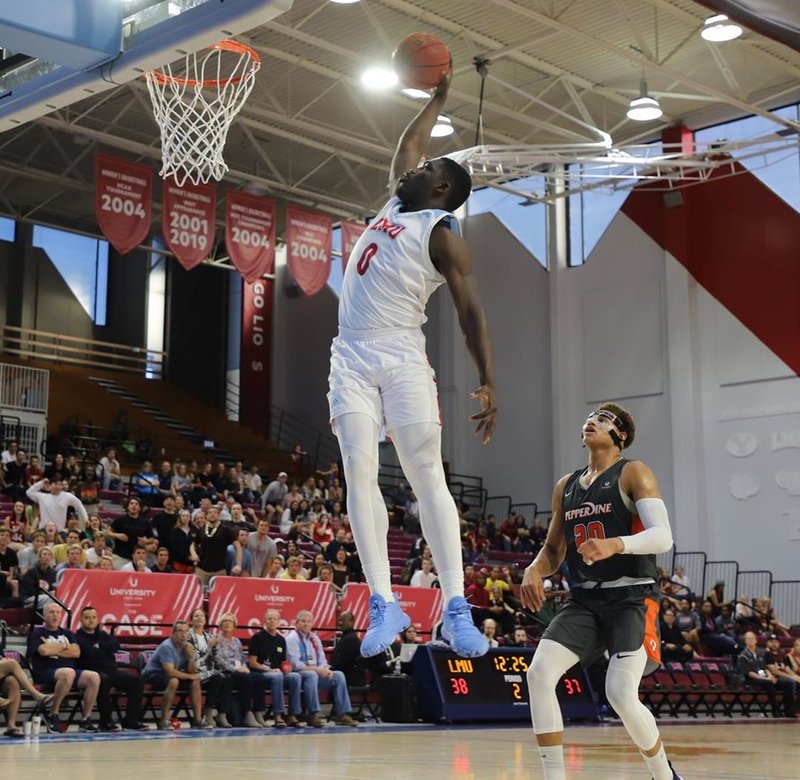 Eli Scott slams home two of his 21 points in the Lions’ overtime defeat against Pepperdine Feb. 2. (LMU Athletics)