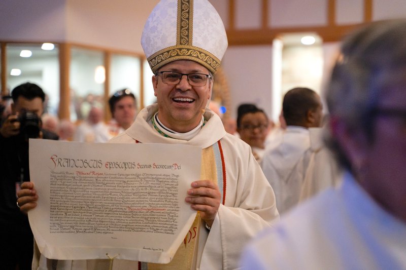 Bishop Alberto Rojas shows the papal bull declaring his appointment as coadjutor bishop of San Bernardino at his Feb. 24 Mass of Welcome. (Diocese of San Bernardino)
