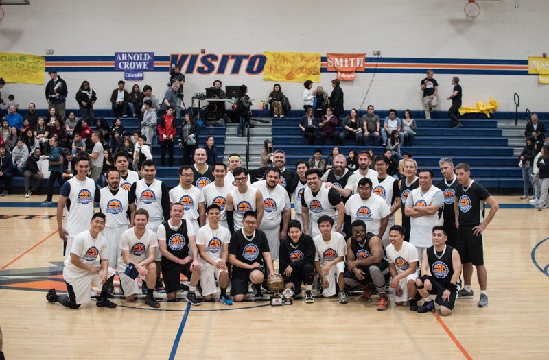 Players from both 11-man #TeamPriest (black) and 20-man #TeamSeminarian (in white) gather for a group shot after the game. (JohnMichael Filippone)