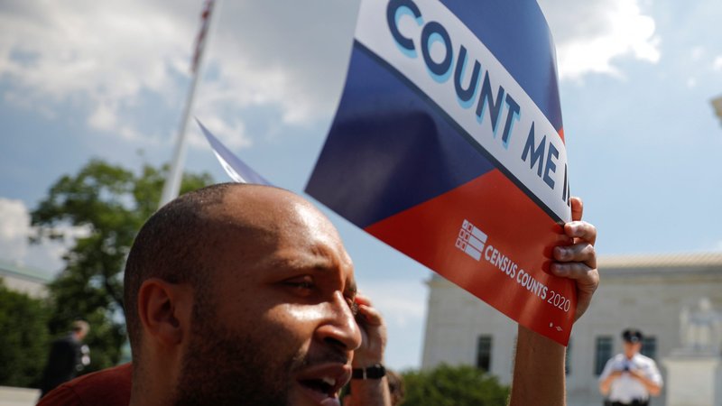 A protester holds a sign outside the U.S. Supreme Court June 27, 2019, after the court ruled on adding a citizenship question to the 2020 census. (Carlos Barria/Reuters via Catholic News Service)
