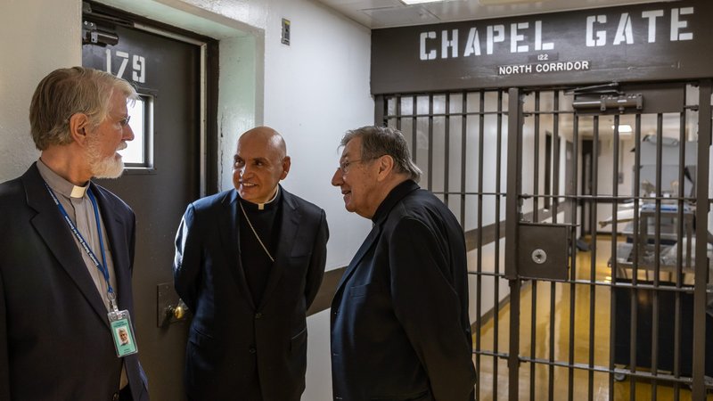 Auxiliary Bishop Mario E. Dorsonville of Washington, center, chairman of the U.S. bishops' Committee on Migration and retired Auxiliary Bishop Denis J. Madden of Baltimore speak with Deacon Chris Schwartz of the Archdiocese of Washington, during a March 2, 2020, trip to Howard County Detention Center in Jessup, Md., for prayer and conversation with migrant detainees held by Immigration and Customs Enforcement. (CNS photo/Jim Waterbury, courtesy In Solidarity)