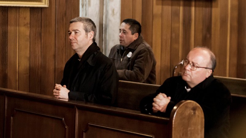 Father Jordi Bertomeu Farnos and Archbishop Charles Scicluna of Malta, who investigated clerical sexual abuse in Chile, are seen praying inside a church in Osorno, Chile, June 14, 2018. Pope Francis will send them to Mexico City March 20-27 to help church leaders with safeguarding and to listen to victims. (CNS photo/Fernando Lavoz, Reuters)