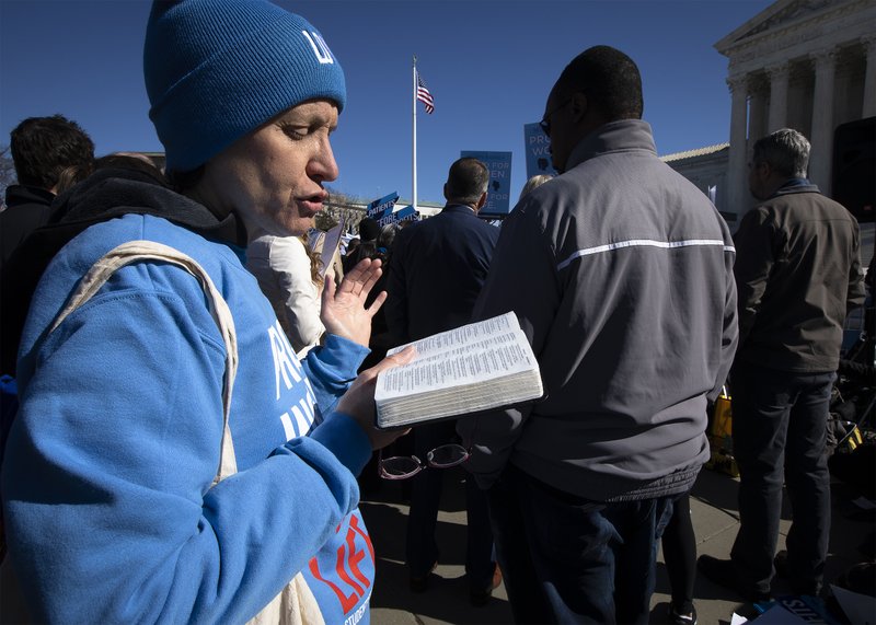 A pro-life demonstrator prays near the U.S. Supreme Court in Washington March 4, 2020. The court heard oral arguments that same day in June Medical Services v. Russo, a challenge to a Louisiana law, passed in 2014, that requires abortion providers to have "active admitting privileges" at a hospital within 30 miles of the abortion facility. (CNS photo/Tyler Orsburn)