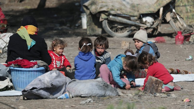 Syrian children sit on the ground at a makeshift camp in Qatmah Feb. 17, 2020. The Sept. 27 celebration of World Day of Migrants and Refugees will emphasize people displaced within their own countries. (CNS photo/Khalil Ashawi, Reuters)