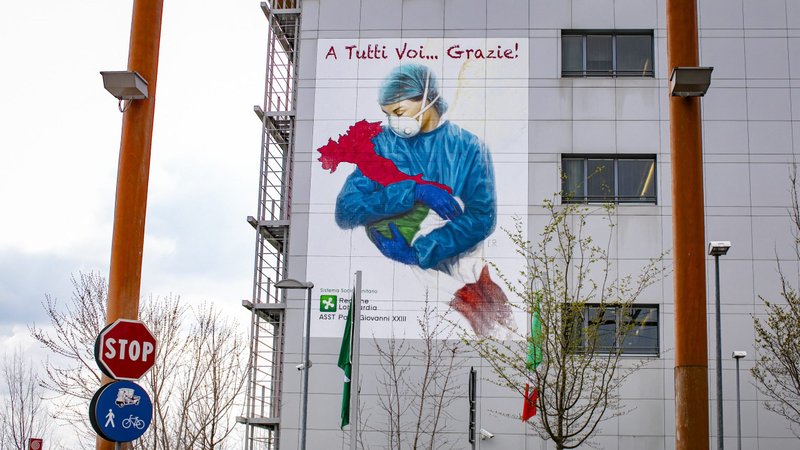 A mural depicts a nurse embracing the shape of Italy posted on the hospital of Pope John XXIII in solidarity with the health workers in Bergamo March 13, 2020. (CNS photo/Sergio Agazzi, IPA/ABACAPRESS.COM via Reuters)