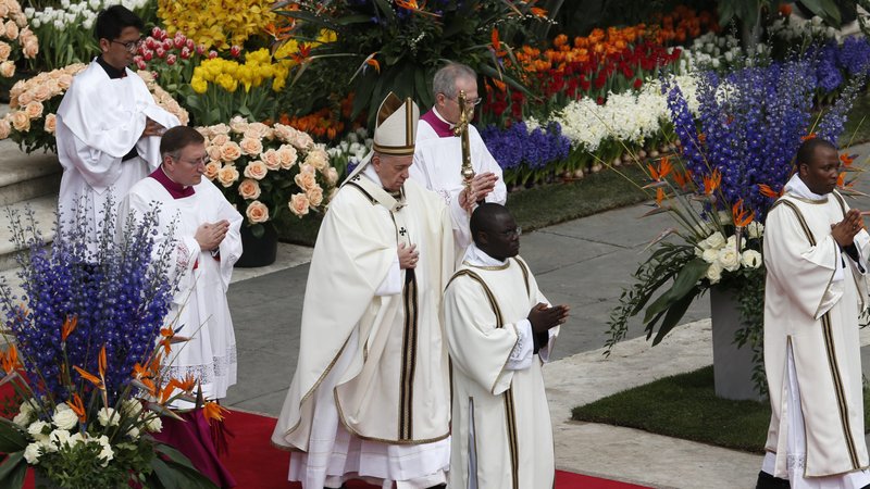 Pope Francis walks past flowers as he celebrates the Easter Mass in St. Peter's Square at the Vatican April 21, 2019. Easter at home is an "opportunity for faith," Cardinal Stella, prefect of the Congregation for Clergy, said March 17, 2020. (CNS photo/Paul Haring)