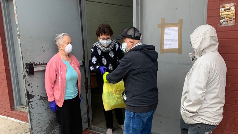 Staff members at the Father English Center in Paterson, N.J., hand out bags of food to those in need March 23, 2020. (CNS photo/courtesy Catholic Charities, Diocese of Paterson)