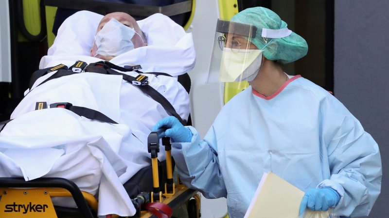 A nurse tends to a patient affected by COVID-19 as he arrives at a hospital in Liege, Belgium, March 23, 2020. Pope Francis expressed his gratitude to the many men and women who have been inspired to help the poor and accompany the sick and the elderly during the coronavirus pandemic. (CNS photo/Yves Herman, Reuters)