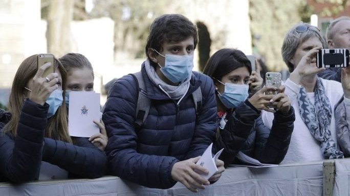 Faithful wear surgical masks as they wait for the arrival of Pope Francis outside the Santa Sabina Basilica on the occasion of the Ash Wednesday Mass opening Lent, the forty-day period of abstinence and deprivation for Christians before Holy Week and Easter, in Rome, Wednesday, Feb. 26, 2020. Pope Francis celebrated the Ash Wednesday ritual kicking off the Catholic Church's Lenten season in traditional fashion, while other Masses in northern Italy were canceled over fears of the new coronavirus. (Gregorio Borgia/AP via Crux)