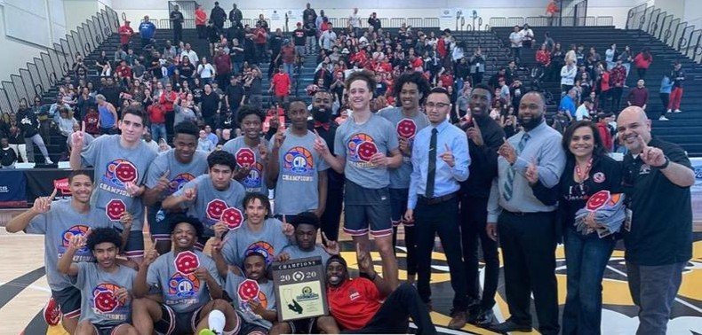 The St. Pius X-St. Matthias Academy boys’ basketball team celebrates its 67-58 victory over Oakwood Feb. 29, earning the Warriors the CIF-SS 4A title. (St. Pius X-St. Matthias Academy)