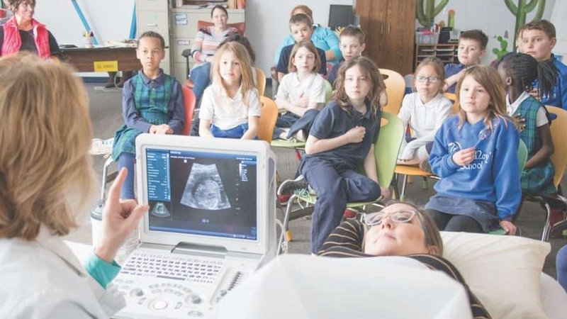 Second-graders at St. Mary School in Bellevue watch a live ultrasound presentation Feb. 28 showing the 21-week-old baby inside Kelly Miller. (Susan Szalewski/Catholic Voice via CNA)