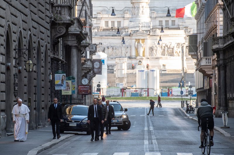 Pope Francis walks along a desolate street in Rome, Via del Corso, while visiting two important pilgrimage sites to pray for the city and the world amid the coronavirus outbreak. (Vatican Media)