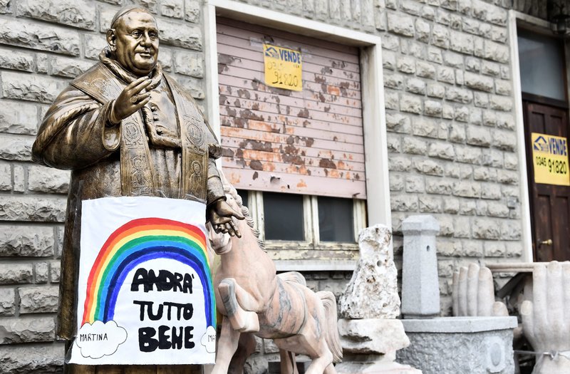 A sign reading "Everything will be fine" hangs on a statue of Pope John XXIII in Zogno, Italy, near Bergamo, March 22. Bergamo is one of Italy's cities worst hit by the coronavirus. (CNS / Flavio Lo Scalzo, Reuters)