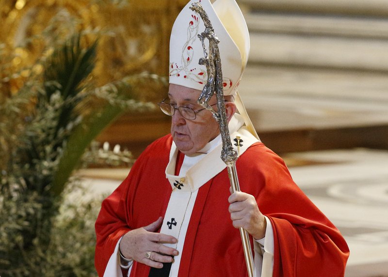 Pope Francis leaves in procession after celebrating Palm Sunday Mass in St. Peter's Basilica at the Vatican April 5, 2020. The Mass was celebrated without the presence of the public as Italy battles the coronavirus. (CNS photo/Paul Haring)