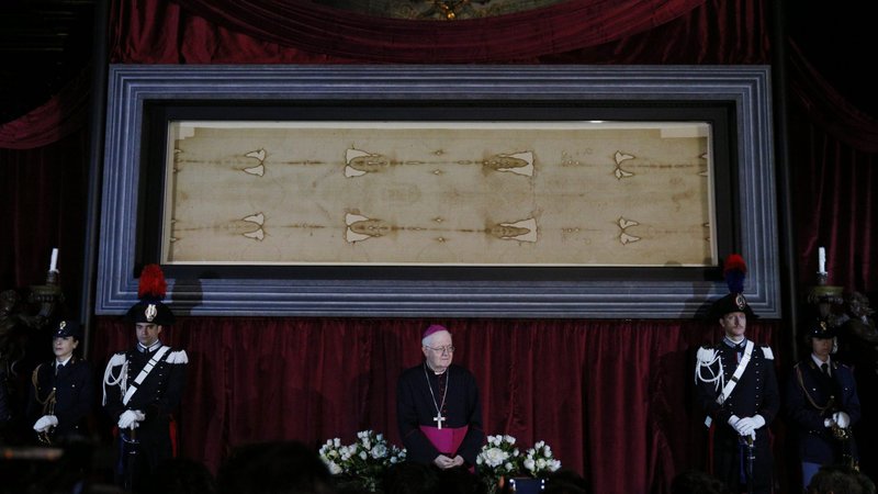 Archbishop Cesare Nosiglia of Turin, Italy, has announced a special live-stream exposition of the Shroud of Turin on Holy Saturday, April 11, at 5 p.m. local time in Turin. Archbishop Nosiglia said he had received "thousands and thousands" of messages asking for the shroud's display as Italy and the world battle the coronavirus. Archbishop Nosiglia is pictured in front of the shroud in the Cathedral of St. John the Baptist in Turin in this April 18, 2015, file photo. (CNS photo/Paul Haring)