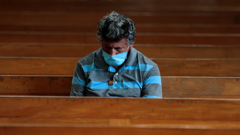 A man wearing a protective mask prays at the Metropolitan Cathedral in Managua, Nicaragua, March 22, 2020, amid the coronavirus pandemic. (CNS photo/Oswaldo Rivas, Reuters)