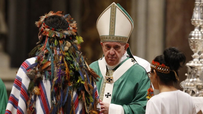 Pope Francis accepts offertory gifts from indigenous people as he celebrates the concluding Mass of the Synod of Bishops for the Amazon at the Vatican in this Oct. 27, 2019, file photo. (CNS photo/Paul Haring)