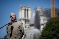 French Army Gen. Jean-Louis Georgelin, in charge of the Notre Dame Cathedral reconstruction, stays at a distance to answer journalists' questions in Paris April 14, 2020, during the coronavirus pandemic. French President Emmanuel Macron has reiterated a pledge to restore the historic cathedral by 2024. (CNS photo/Benoit Tessier, Reuters)