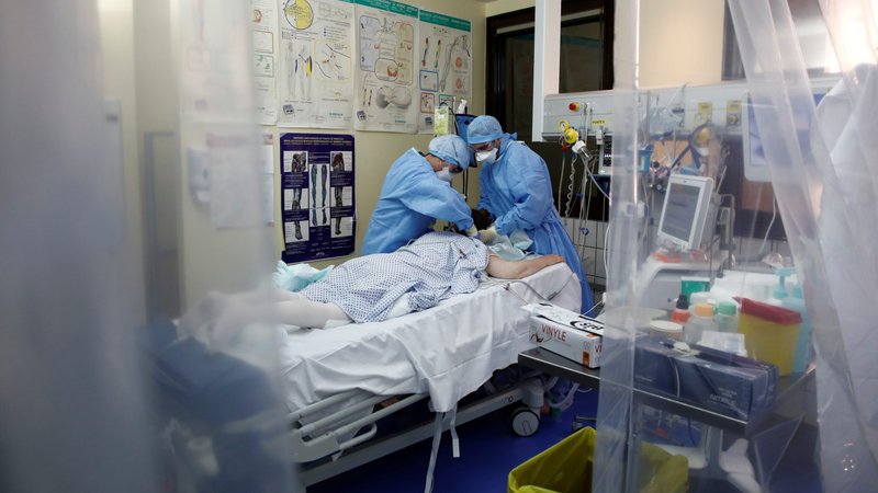 Medical staff, wearing protective suits and face masks, treat a patient suffering from COVID-19 in an intensive care unit of a hospital near Paris April 15, 2020. Pope Francis created a new commission that will confront the challenges the world is facing in battling the coronavirus pandemic and what it will inevitably face in its aftermath, the Vatican announced in a statement published April 15. (CNS photo/Benoit Tessier, Reuters)
