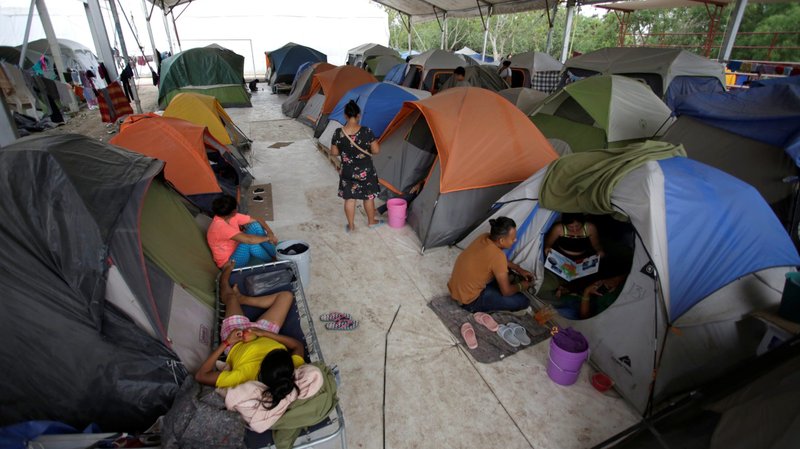Asylum-seekers are seen outside of tents at an encampment in Matamoros, Mexico, April 9, 2020. (CNS photo/Daniel Becerril, Reuters)