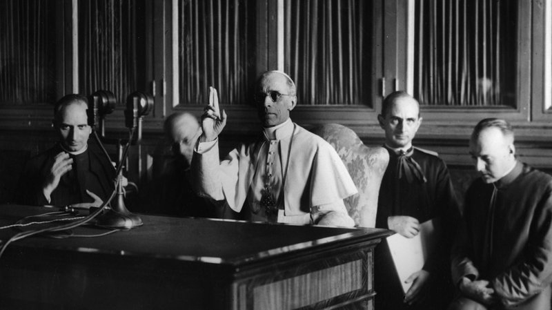 Pope Pius XII gives a blessing at the end of a radio message Sept. 1, 1943. The COVID-19 pandemic came at the worst time for scholars and historians who had been waiting for the March 2 opening of the Vatican's archives on Pope Pius XII. (CNS photo)