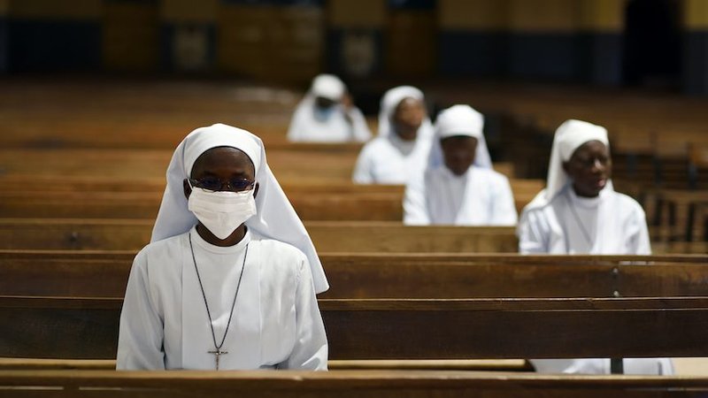 Nuns attend Holy Thursday Mass in a nearly empty cathedral April 9, 2020, in Ouagadougou, Burkina Faso, during the COVID-19 pandemic. (CNS photo/Anne Mimault, Reuters)