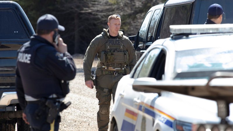 Royal Canadian Mounted Police stand along a road in Portapique, Nova Scotia, April 19, 2020, after a shooter went on 12-hour rampage that left at least 19 people dead. (CNS photo/John Morris, Reuters)