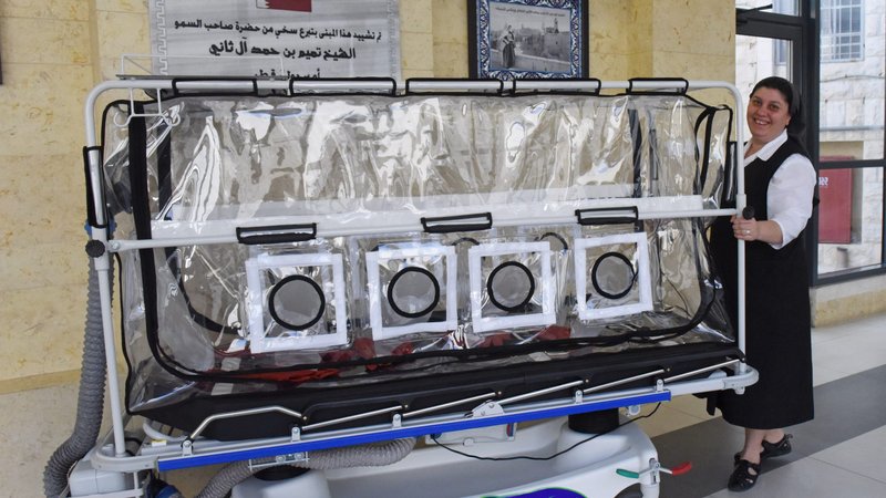 Sister Lida Maqus, superior of the Sisters of St. Joseph at St. Joseph's Hospital in East Jerusalem, shows an isolation trolley in the COVID-19 unit on the hospital grounds to transport coronavirus patients April 16, 2020. (CNS photo/Debbie Hill)