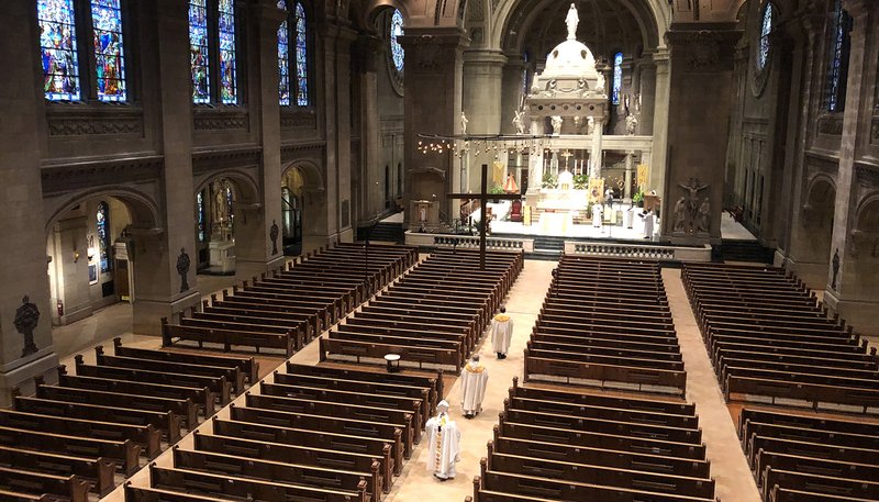Archbishop Bernard A. Hebda of St. Paul and Minneapolis processes in an empty Basilica of St. Mary in Minneapolis for Easter Mass April 12, 2020. (CNS photo/Dave Hrbacek, The Catholic Spirit)