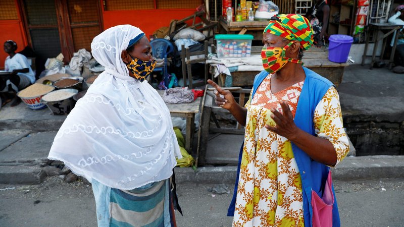 Women wearing protective masks chat at a market in Accra, Ghana, April 20, 2020, during the COVID-19 pandemic. Ghana's religious leaders have declared three days of national prayer and fasting April 24-26 to seek God's intervention and direction in the fight against COVID-19. (CNS photo/Francis Kokoroko, Reuters)