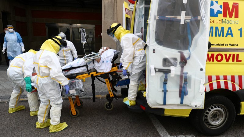 Members of Madrid's Emergency Service wearing protective equipment transfer a patient to another hospital April 20, 2020, during the COVID-19 pandemic. Pope Francis donated respirators, masks and protective eyewear to several countries, including Spain, on the April 23 feast of his namesake, St. George, Vatican News reported. (CNS photo/Sergio Perez, Reuters)